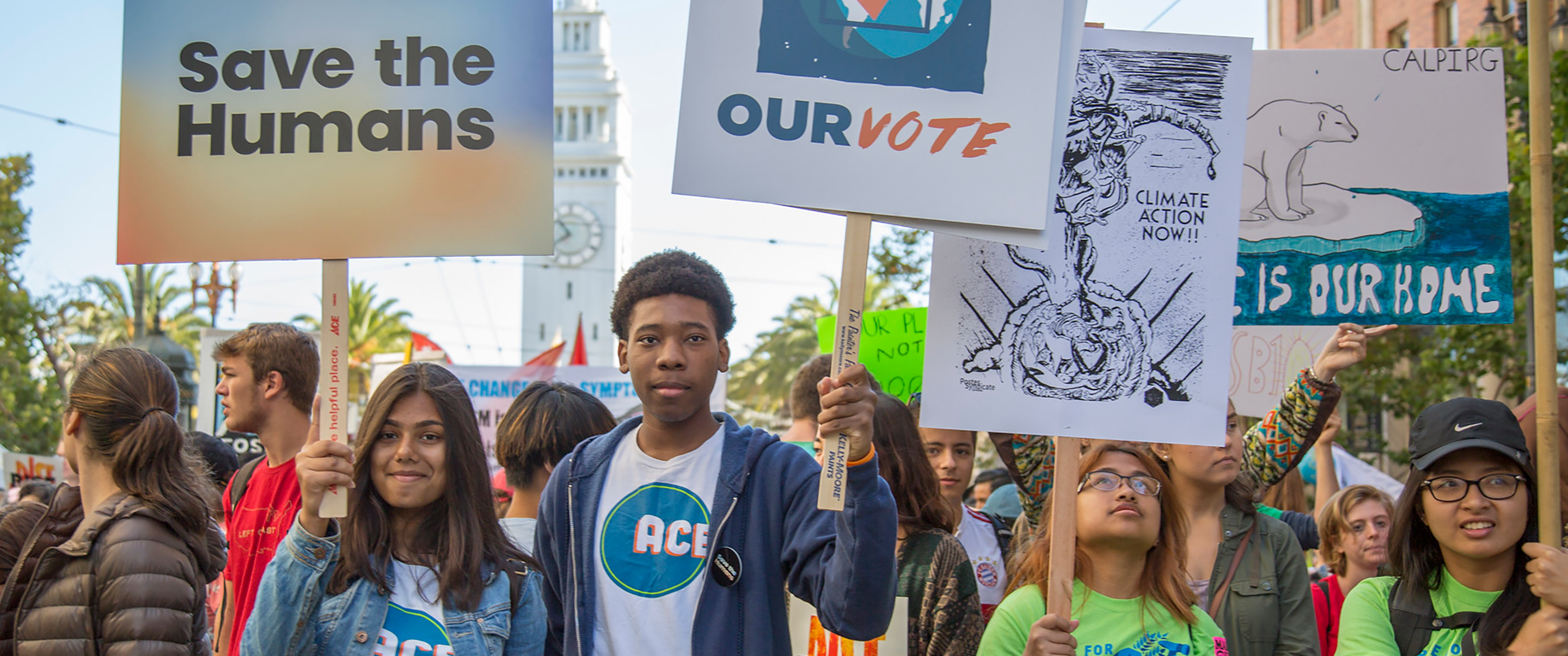 A crowd of young people holding protest signs to fight climate change 