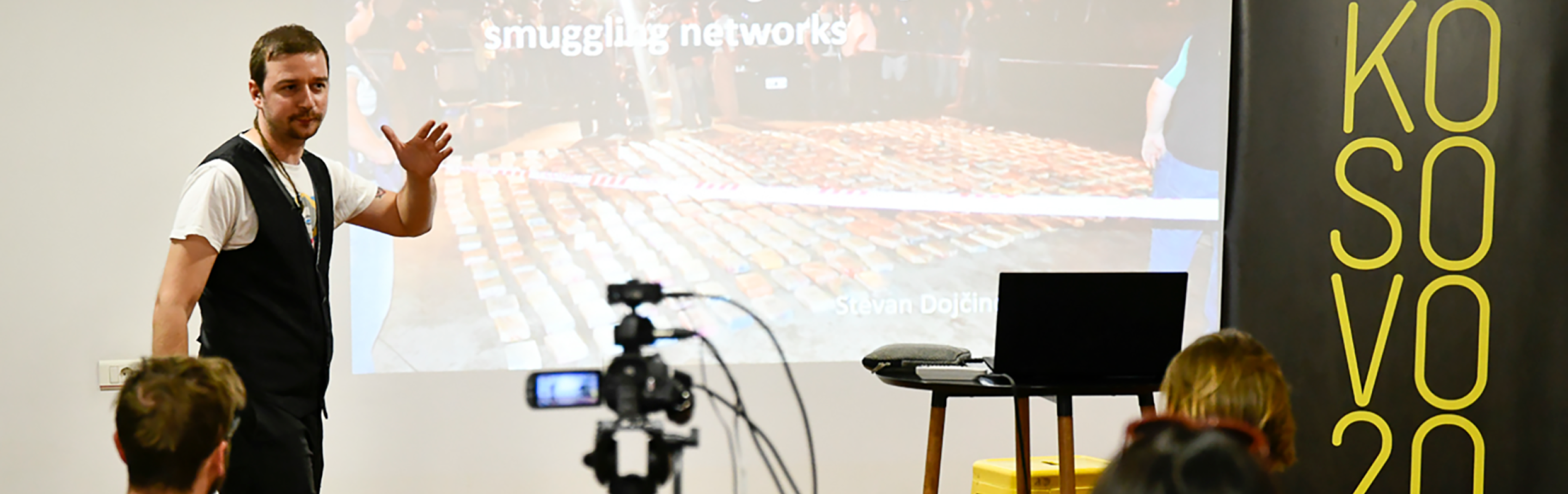 a camera films a man presenting on how to investigate smuggling networks