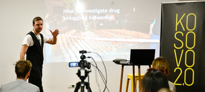 a camera films a man presenting on how to investigate smuggling networks
