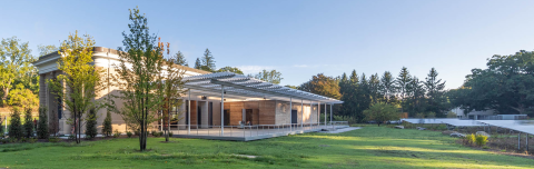 the terrace of the David Rockefeller Arts Center surrounded by solar panels and trees.