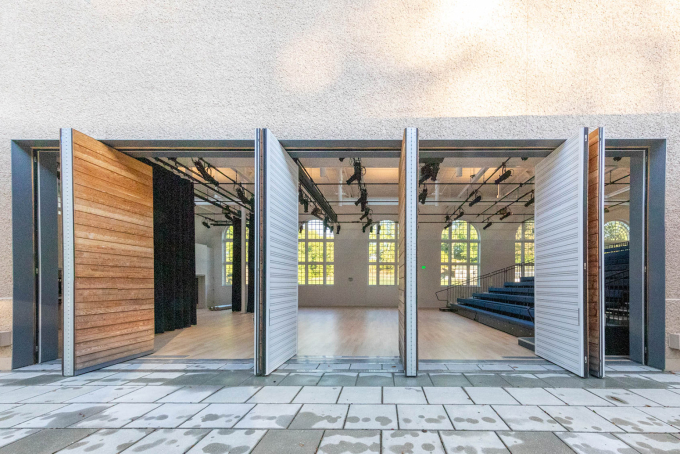 A view from outside through the pivot doors into the DR Center performance space