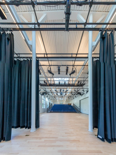 Backstage at the DR Center, framed by curtains, with a view into the audience seating. 