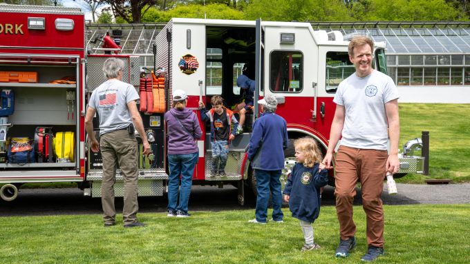 Families explore a firetruck with the Pocantico Hills Fire Department