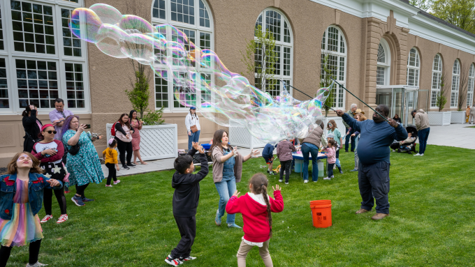 Children play with bubbles with The Bubble Man NYC