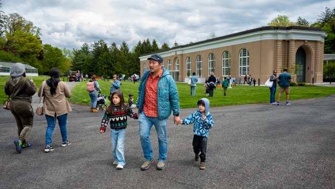 Families walk alongside the David Rockefeller Creative Creative Arts Center
