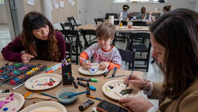 Families paint clay pennants