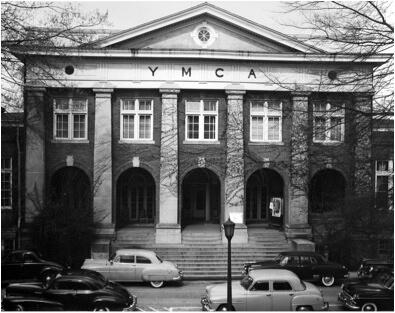 Black and white photo of an imposing building with "YMCA" written on it.