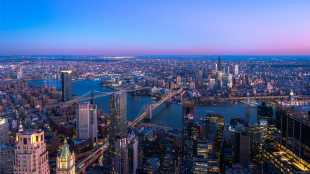 Skyline of Manhattan New York City during the night.View of Brooklyn and Manhattan Bridge over East River.