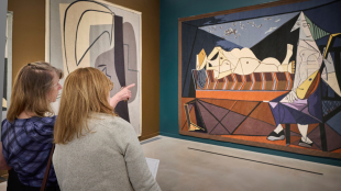 Two visitors view large handwoven tapestries based on Pablo Picasso’s artworks in the Woven Wonders: Kykuit’s Picasso Tapestries exhibition at the David Rockefeller Creative Arts Center.