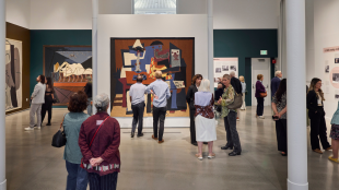 Visitors view tapestries and exhibition displays during the opening reception of Woven Wonders at the David Rockefeller Creative Arts Center.
