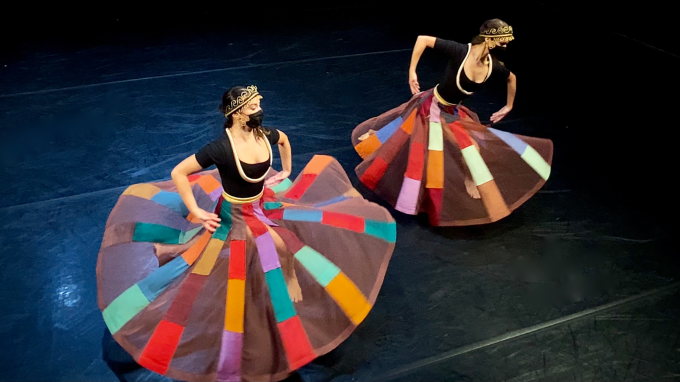Two female dancers in flowing dresses