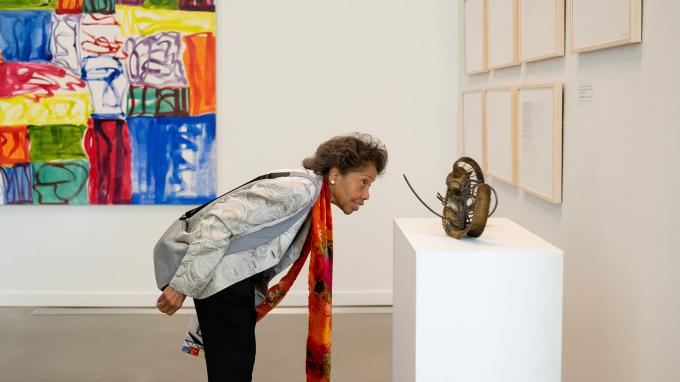 Woman looks at a sculpture in the Inspired Encounters Exhibit of the DR Center